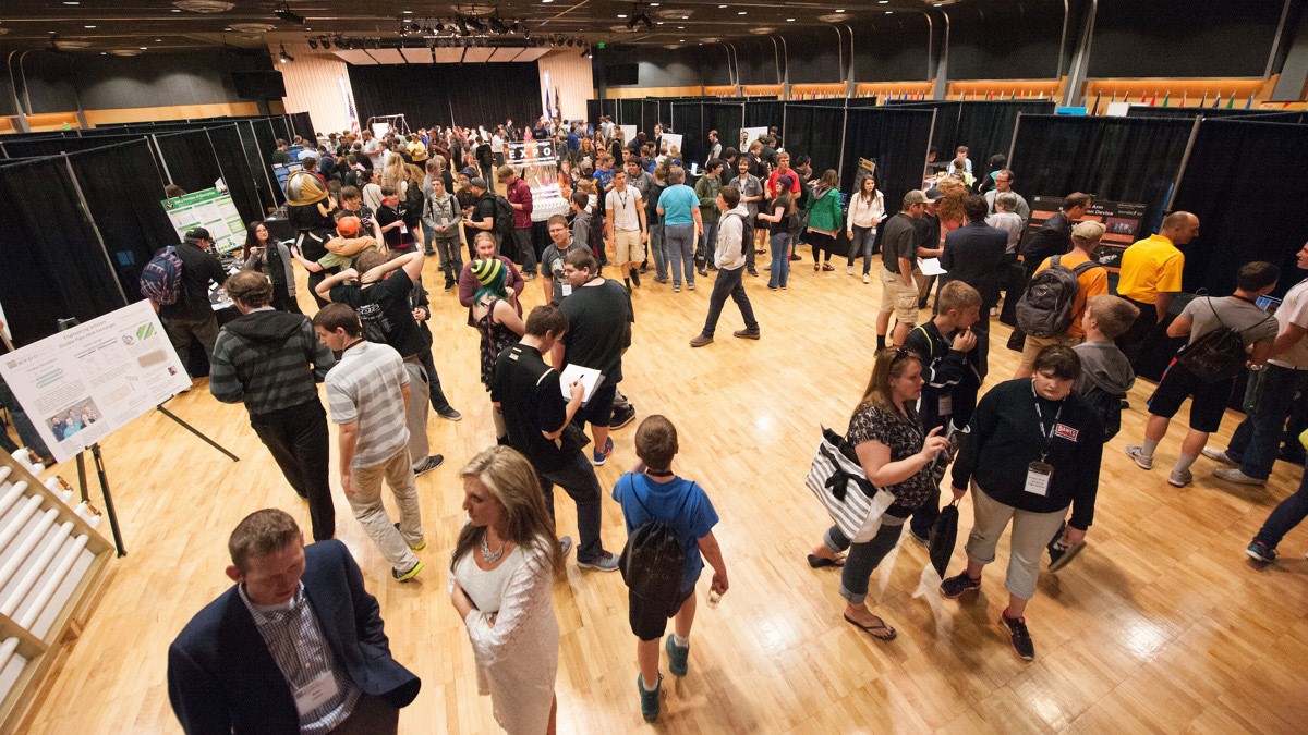 Visitors examine exhibits during an expo held in the International Ballroom