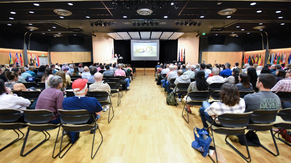 Audience views a presentation in the International Ballroom