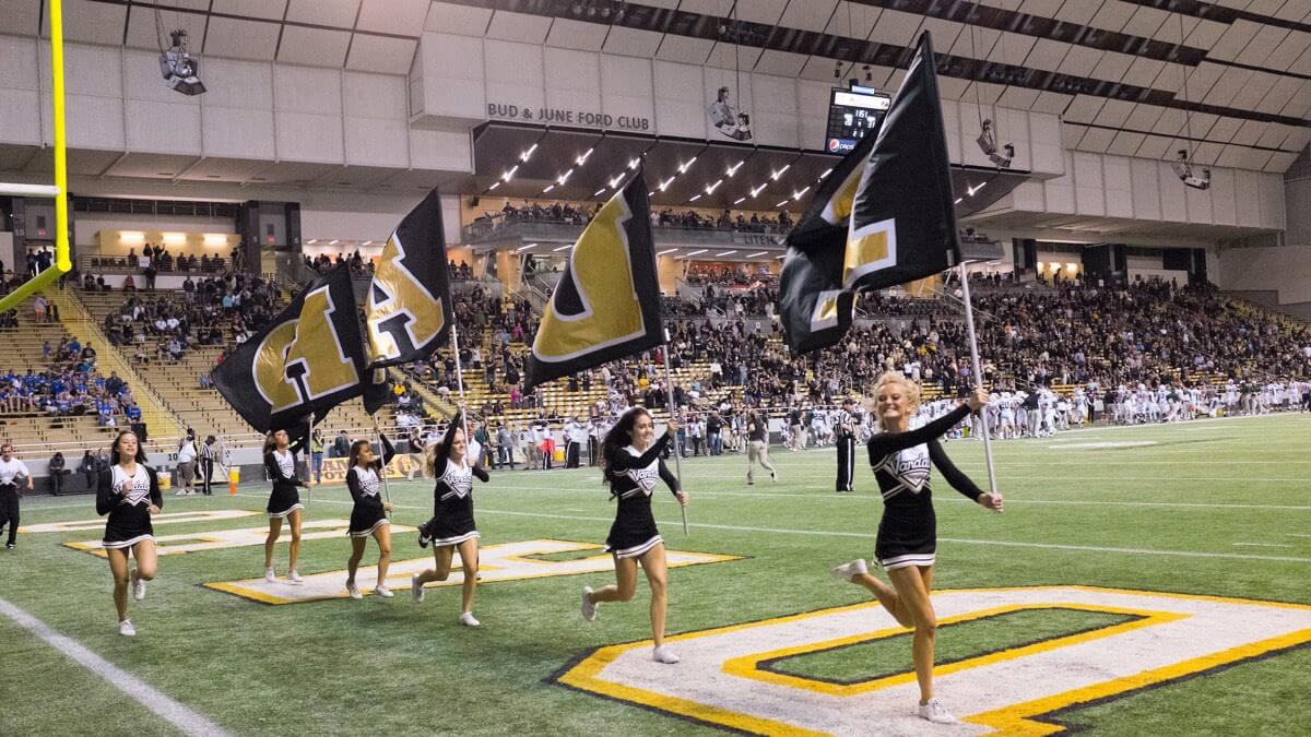 Vandal Cheer Squad runs across the Idaho inzone inside the ASUI Kibbie Activity Center