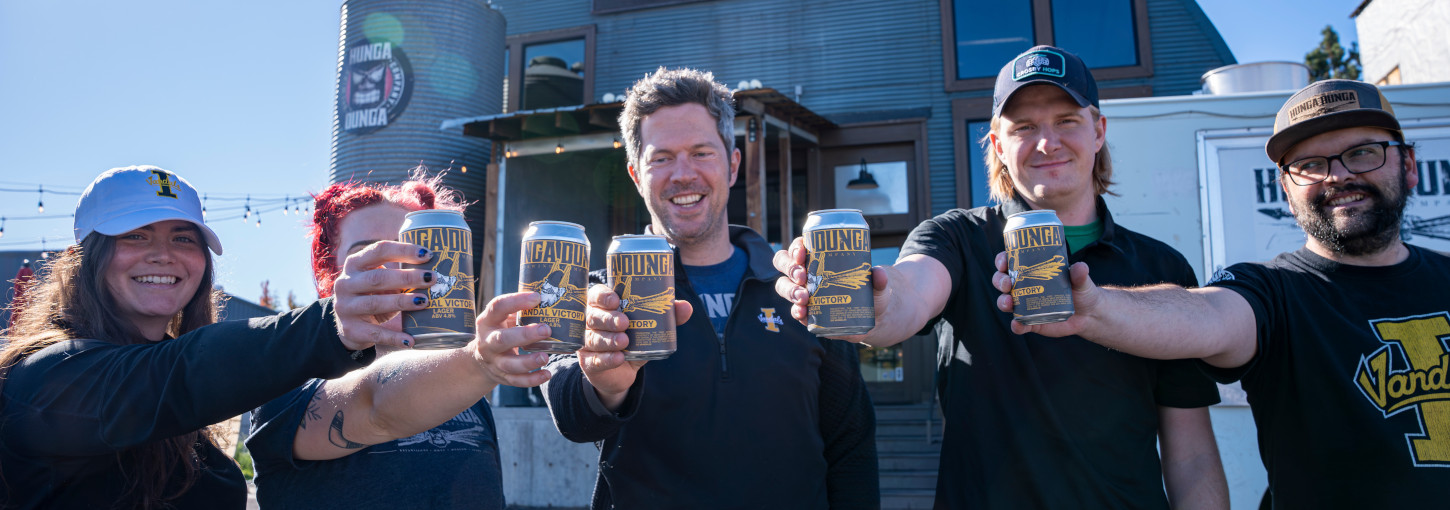 Five people hold beer cans.