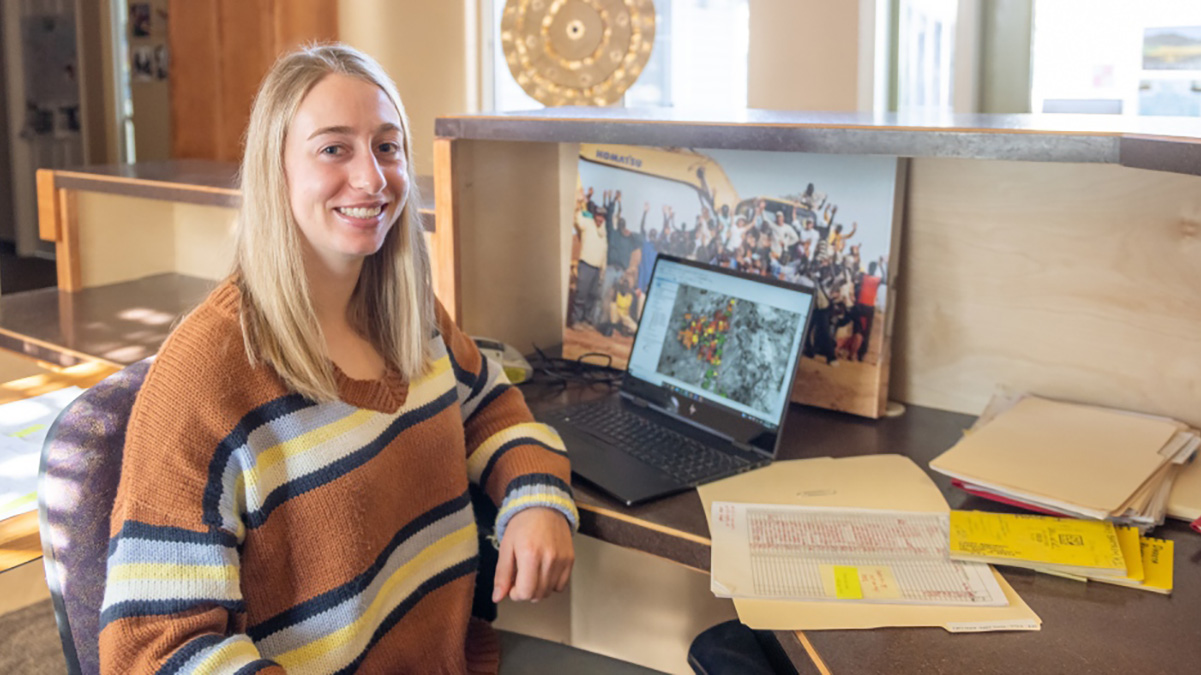 Madison Thurston sits at her computer with a mapping program visible.