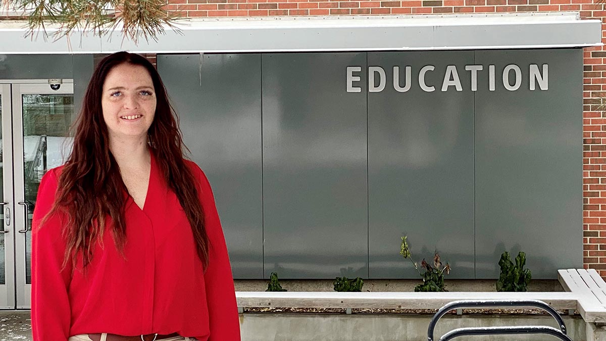 Deanna Bakken standing in front of CEHHS building.