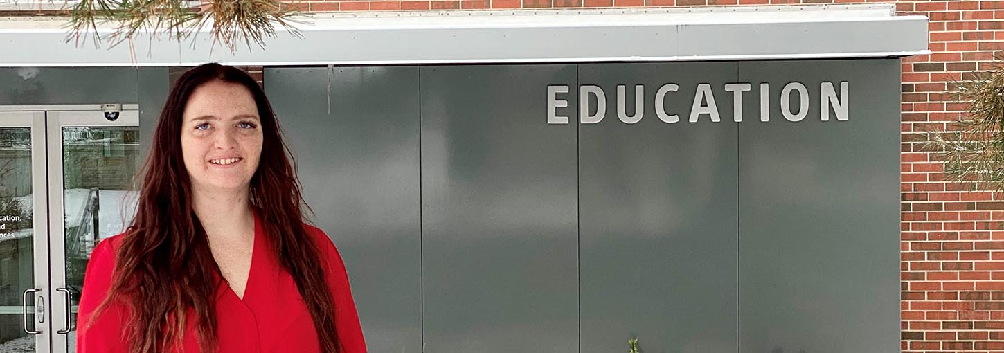 Deanna Bakken standing in front of CEHHS building.