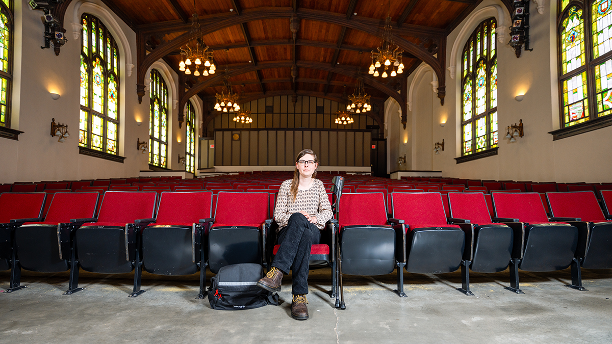 Woman sitting in empty theater.