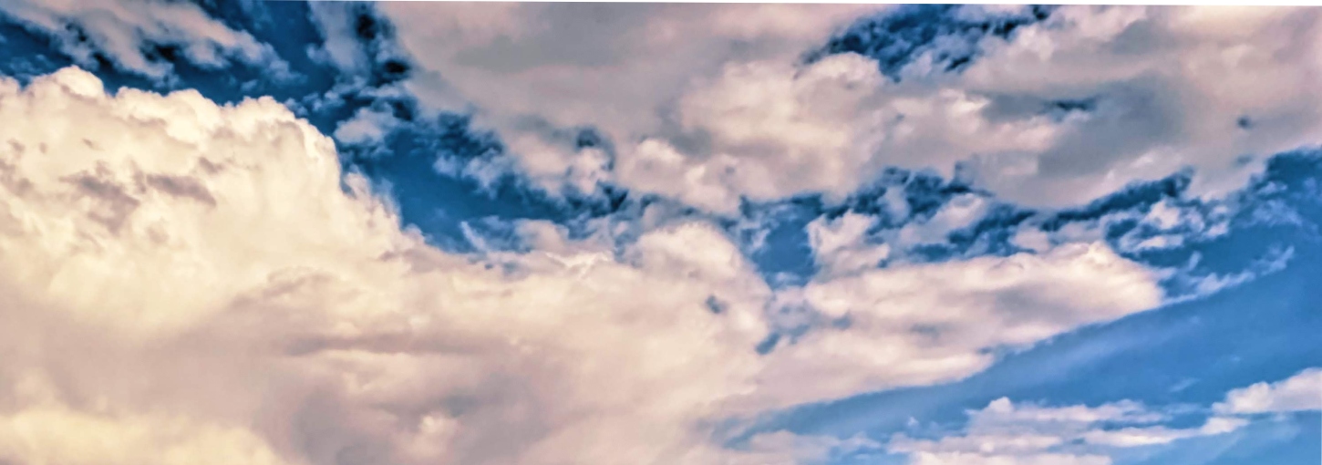 White clouds float in a blue sky.