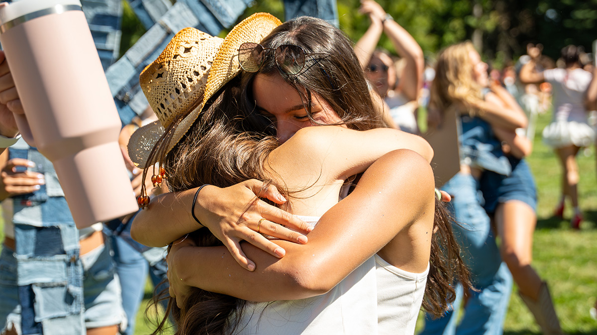 Two students hug on the Administration Building Lawn.